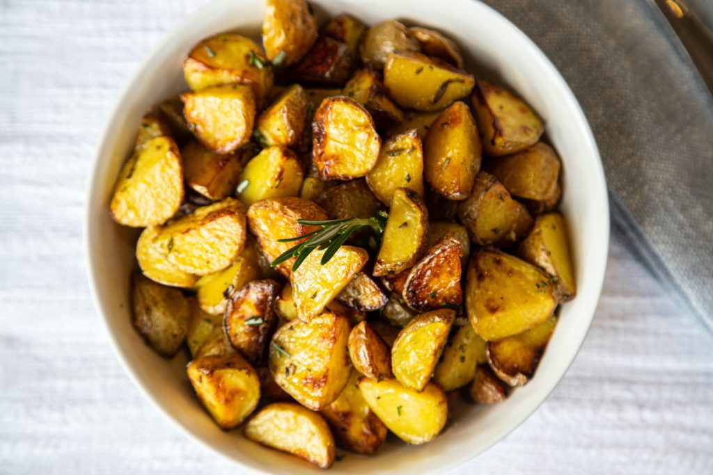 roasted potatoes in a bowl with rosemary