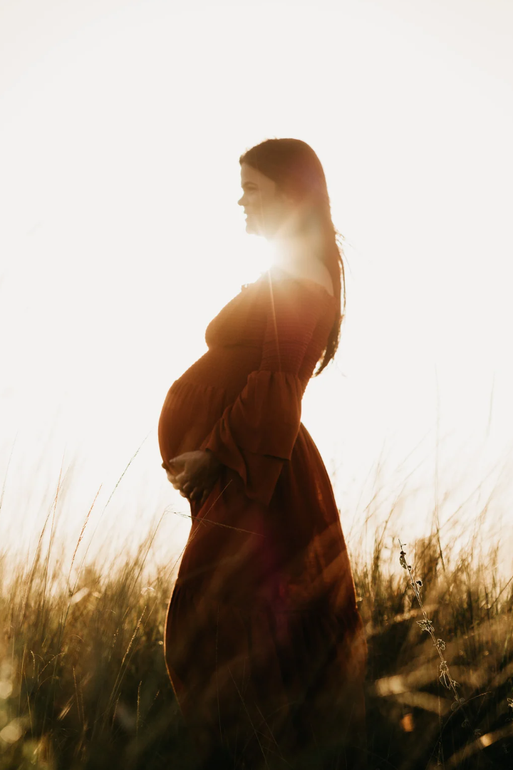 pregnant woman outside with sunshine