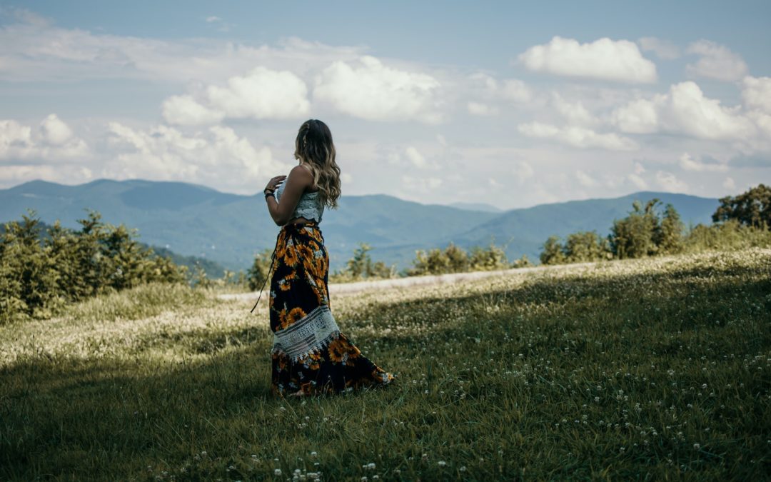 woman standing in front of blue ridge mountains