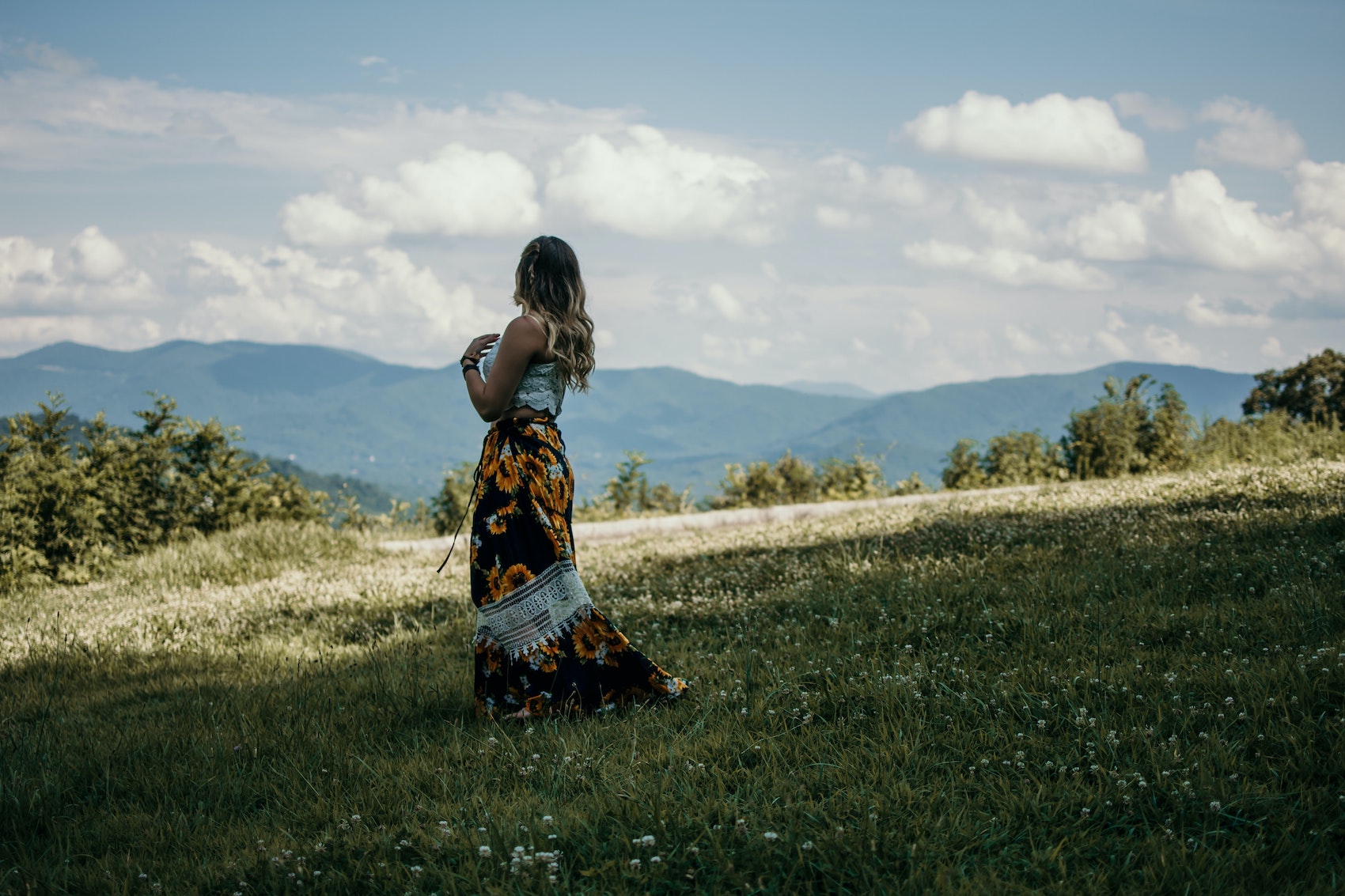 woman standing in front of blue ridge mountains